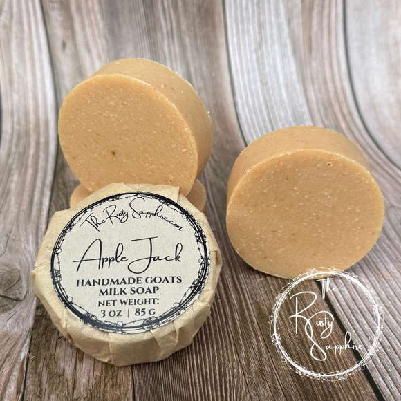 Handmade goats milk soap with a label on a wooden surface, featuring the Rusty Sapphire brand.