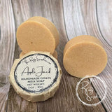 Handmade goats milk soap with a label on a wooden surface, featuring the Rusty Sapphire brand.